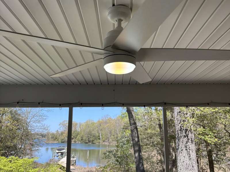 Ceiling fan with light on a screened porch overlooking the water